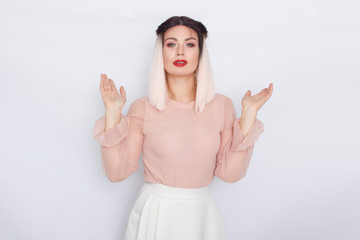 Romantic portrait of blonde woman in light pink blouse and white skirt