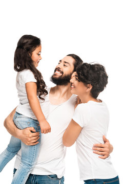bearded latin man holding in arms adorable daughter while smiling near wife isolated on white