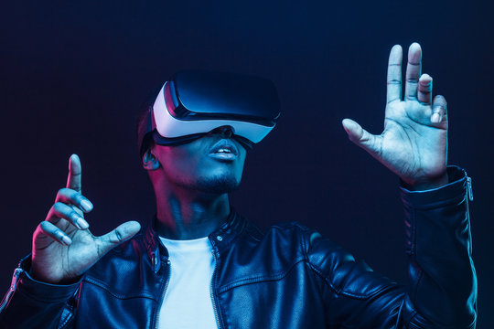 African american man in vr glasses, watching 360 degree video with virtual reality headset isolated on black background