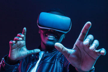 African man wearing virtual reality headset having great fun