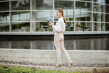 Beautiful business woman is working outside office