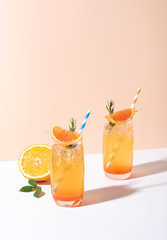 Cold and refreshing orange punch cocktail with orange slice on color background. summer drink.