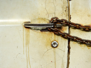 old white car door with chain