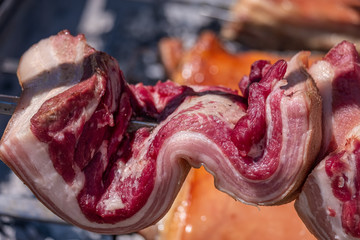 Traditional sardinian pancetta (Pork Lard, Bacon) in an open grill in Sassari, Sardinia, Italy - obrazy, fototapety, plakaty