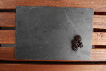 delicious blackberries on blackboard background