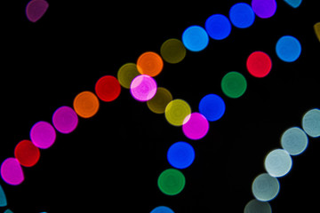 Colorful curved lines with lights of various colors with a Bokeh effect.