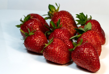 red strawberries lay on the table, harvest