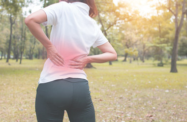 sport women has waist pain or injured and workout as exercise in park