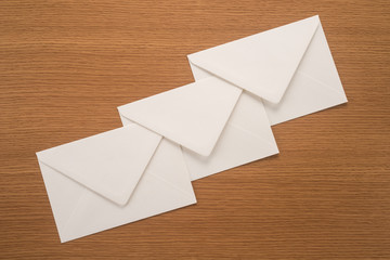 White envelopes on a wooden background