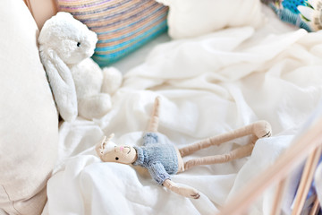 Hare toy dolls on the white sheet, bed with pillows