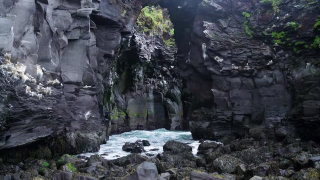 Rocky coastline landscape in Hellnar, Iceland. Hellnar was among the largest fishing villages beneath the Snaefellsjokull ice cap in West Iceland.