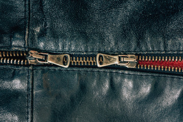 Steel zipper on a leather jacket on a white background. Metal clasp on the jacket. Iron strong...