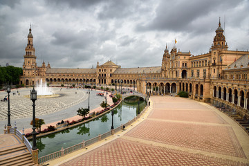 Fototapeta na wymiar North tower and Main building with canal and bridges at Plaza de Espana Seville