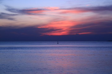 Vibrant orange color sunset afterglow over the blue sea
