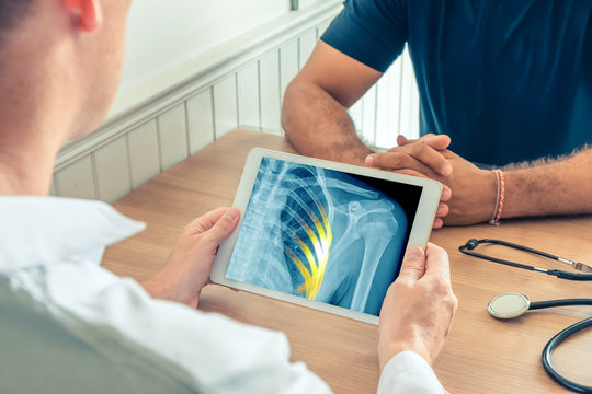 Doctor holding a digital tablet with x-ray of the chest of the patient. Pain on the ribs