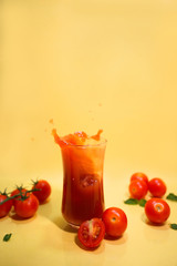 tomato juice splashes on yellow background.