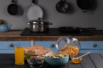 Traditional breakfast. Healthy food. Organic lunch. Delicious snaсk - baguette with cheese and tomato, sandwich with salad and meat. Black table. Kitchen