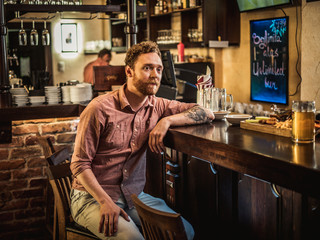 Man tasting fresh beer in a pub