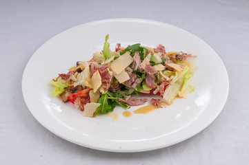 caesar salad on a white plate on a pure white background