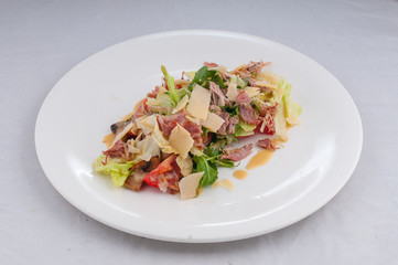caesar salad on a white plate on a pure white background