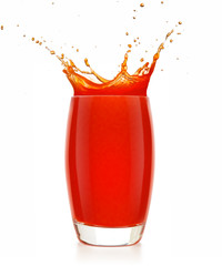 red juice splashing out of a glass isolated on white background