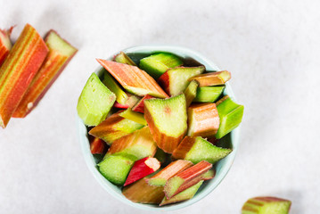 Pieces of Raw and Freshly Cut Rhubarb on Grey Background