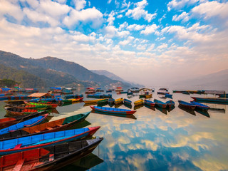 The Boats with different colors,the Sky reflection in the water.