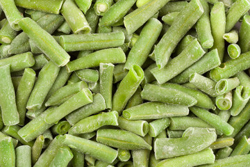 Close up of frozen green beans. Whole background.