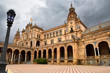 Fototapeta na wymiar Empty square and dark clouds at the Main Building of Plaza de Espana Seville Spain