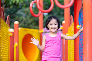 Asian Chinese little girl playing at outdoor playground