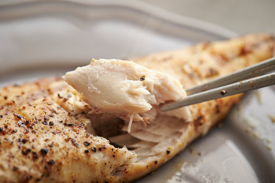 Grilled mackerel fish, eating with chopsticks