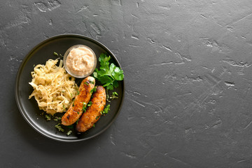 Stewed sauerkraut with grilled sausages - obrazy, fototapety, plakaty