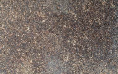 Background of dark stone with multi-colored splashes. Natural texture