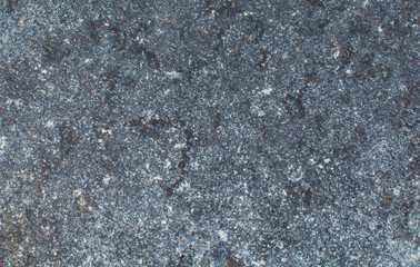 Background of dark stone with multi-colored splashes. Natural texture
