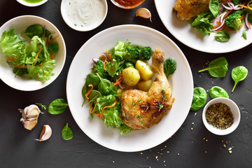 Grilled chicken leg with potato and green salad