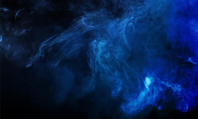 Blue smoke over black studio background