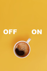 Cup of coffee on yellow background, switched on, concept