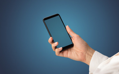 Mockup for female hand using frameless smartphone with dark background
