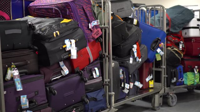 Luggage trolleys with a large pile of suitcases