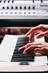 Obraz premium pianist hands playing white piano in recording studio