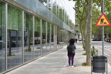 city street in perspective with modern glazed facades, people and trees