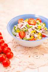 Rice salad with pork steak, tomatoes, corn seeds and tomatoes.