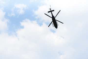 bottom view of helicopter flying in sky with copy space