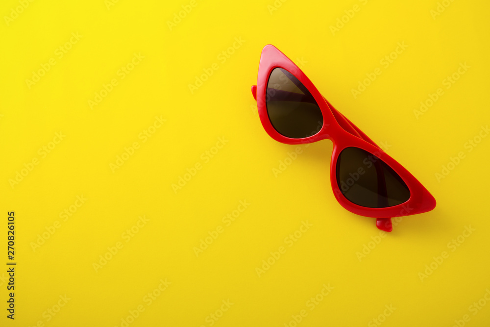 Wall mural retro sunglasses on yellow background