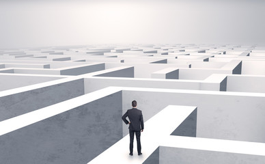 Small businessman in a middle of a huge maze
