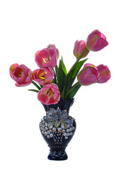 Bouquet of beautiful pink tulips in a small blue vase on a neutral white background