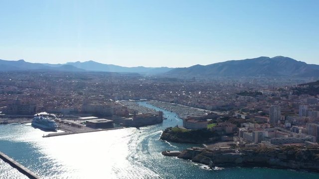 Right to left aerial traveling Marseille harbor Vieux Port big ferry mucem museum sunny day