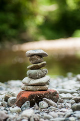 Fototapeta na wymiar Closeup of stone balance in border river