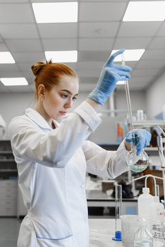 red-haired woman works in the medical laboratory