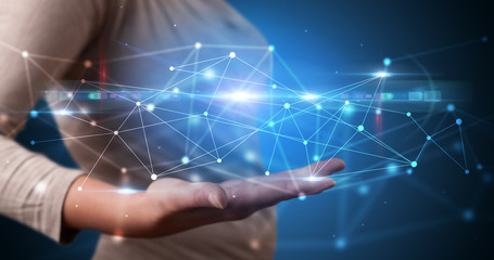 Handsome person holding hologram screen displaying modern cloud based web system technology
